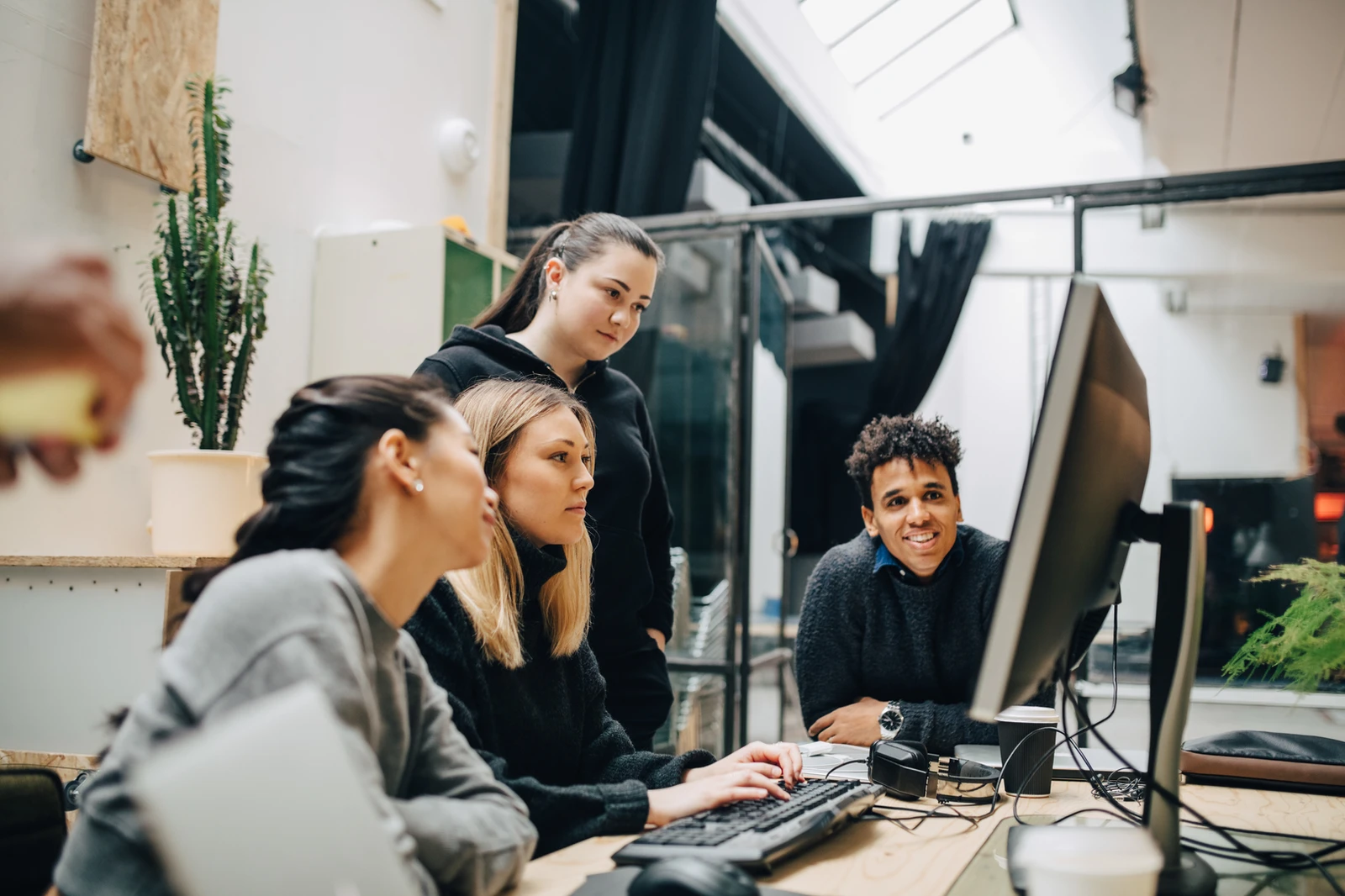 Healthcare students collaborating around a computer